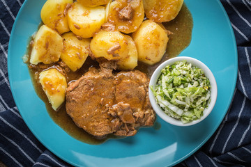 Braised meat in sauce served with boiled potatoes.