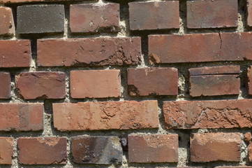 Old red brick wall with crushed mortar