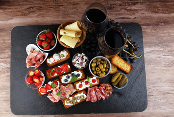 Italian antipasti wine snacks set. Cheese variety, Mediterranean olives, pickles, Prosciutto di...
