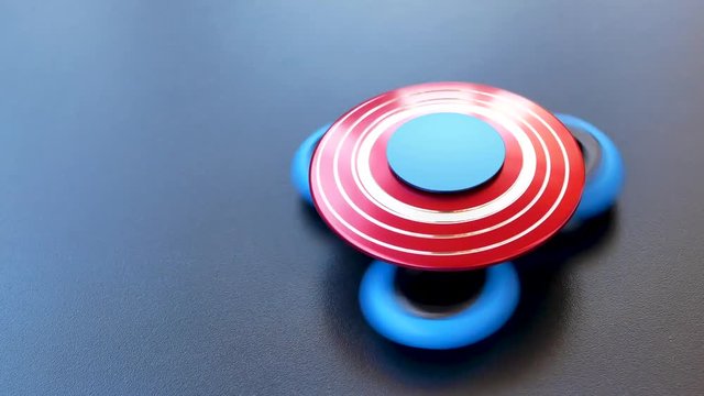 Popular colourful fidget spinner toy on a black background