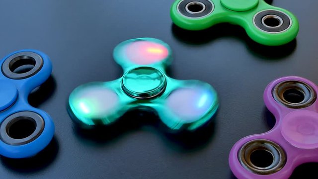 Popular colourful fidget spinner toy on a black background