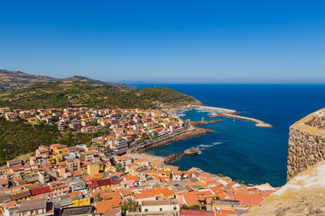 Naklejka na ściany i meble Castelsardo, Italy. A picturesque view of the city and the port from the fortress walls