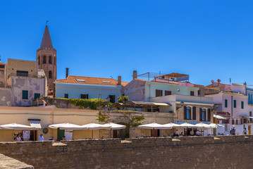 Alghero, Sardinia, Italy. Fortress wall and old buildings on the waterfront
