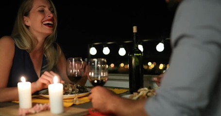 Beautiful couple in love having romantic dinner at night