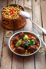 izmir kofte, Turkish traditional meatballs in copper pan with spicy chickpeas