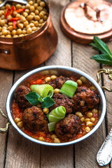izmir kofte, Turkish traditional meatballs in copper pan with spicy chickpeas