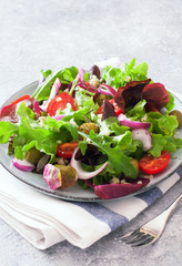 Vegetarian salad with lettuce, tomatoes, olives and bulgur