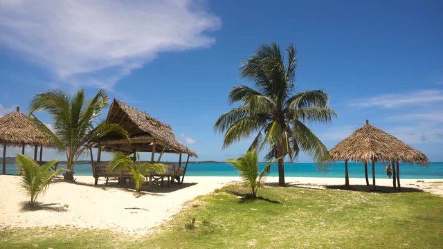 Beach with white sand with beach house on a tropical island Daco. Beautiful sky, sea, resort. Seascape: Ocean and beautiful beach paradise. Philippines. 4K video. Travel concept.