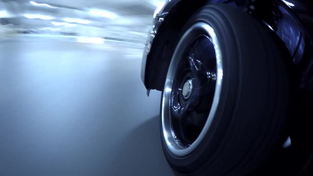 Time lapse wheel reflecting in parking garage 