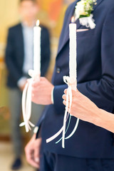 Young couple holding two candles