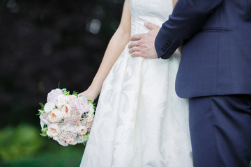 bride and groom holding wedding bouquet