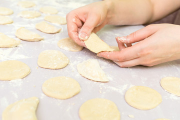 Woman's hands make ravioli