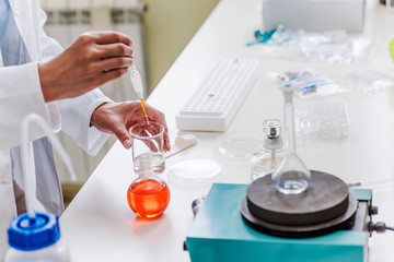 Hands of chemist doing lab experiment or test