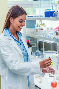 Woman scientist carrying out experiment in research laboratory