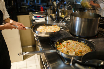 Risotto in a pan being cooked in a restaurant