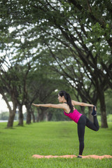 Young woman practicing yoga in park