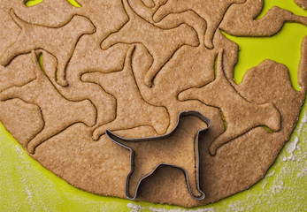 Making homemade dog treats in the shape of a bone.