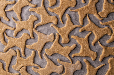 Making homemade dog treats in the shape of a bone.
