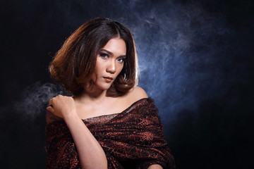 Fototapeta premium Asian Woman Fashion Make Up brunette hair, studio lighting black background