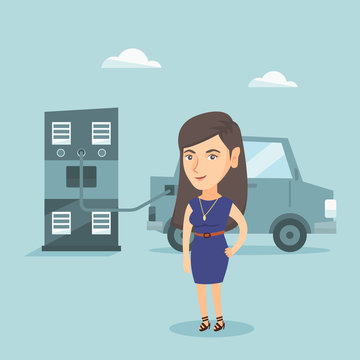 Young caucasian woman charging her electric car at the charging station. Happy smiling woman standing near power supply for charging of electric car. Vector cartoon illustration. Square layout.