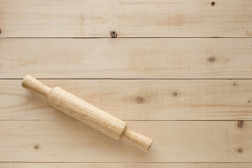 wooden rolling pin on brown table
