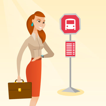 Caucasian business woman waiting for a bus at the bus stop. Young cheerful woman standing at the bus stop. Woman looking at her watch at the bus stop. Vector cartoon illustration. Square layout.