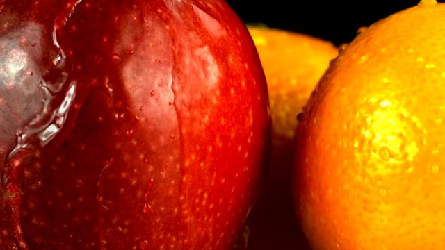 Slow Motion Footage Of An Apple And An Orrange Splashed By Water Stream - Close Up.mov