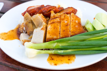 Barbecued red pork in sauce with rice on the table
