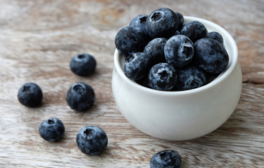 Blueberry on wooden table background.