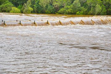 Fast flowing water over flooded bridge to Russet Park