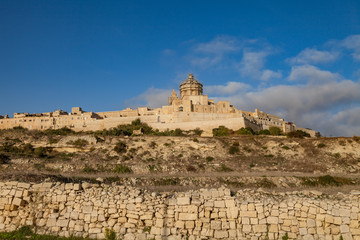 Fototapeta na wymiar Ancient hilltop fortified by old capital city of Malta, The Silent City, Mdina or Rabat, skyline at sunrise.