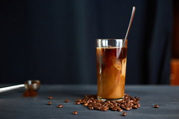 Iced coffee in a tall glass with cream
