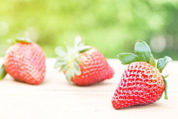 Strawberries with blurry green background