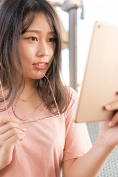 asian girl watching tablet