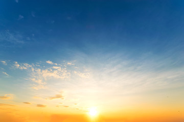 Sky background at sunset,Sky blue and orange light of the sun through the clouds in the sky