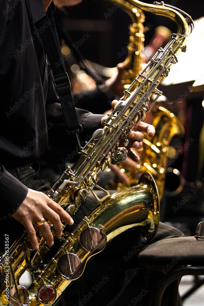 Wall mural hands musician playing the saxophone in a jazz band