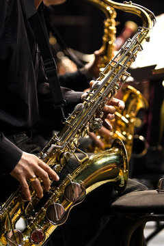  Hands musician playing the saxophone in a jazz band
