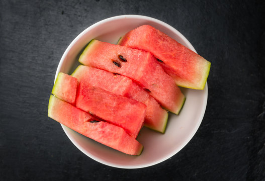 Some Sliced Watermelon on a dark slate slab