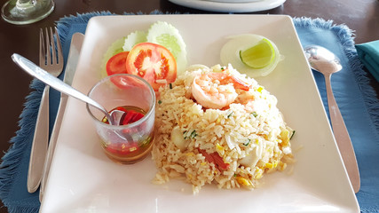 Fried rice with shrimp on white square tile plate