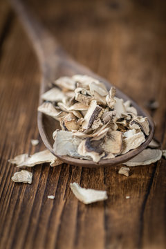 Wooden table with Dried white Mushrooms, selective focus