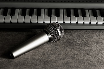 The microphone rests on the piano keys