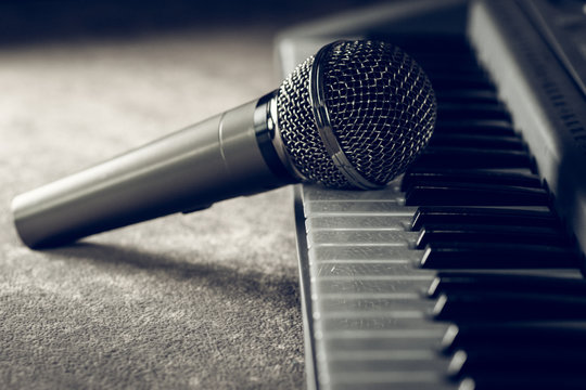 The microphone rests on the piano keys
