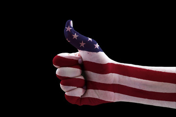 Stars and stripes painted on hand, isolated on black