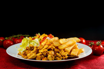 Fresh chicken with tomatoes and french fries
