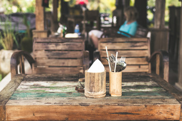 Wooden table in a small cafe in the rainforest of tropical Bali island, Indonesia.