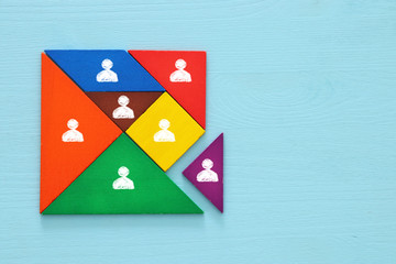 tangram puzzle blocks with people icons ,human resources and management concept.