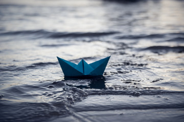 Blue lonely paper boat
