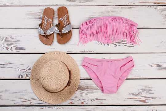 Pink bikini set, hat, sandals.