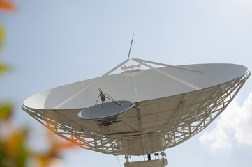 Shot of a satellite dish pointing up on a clear blue sky for a good data communication link.
