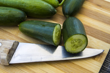 Fresh cucumber pictures on a white background, natural and organic cucumbers, cucumber pictures cut with a knife in a basket
